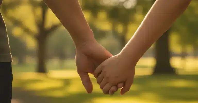 Photorealistic image of a pair of adult hands gently holding a small child's hand while walking through a sunlit park with gr